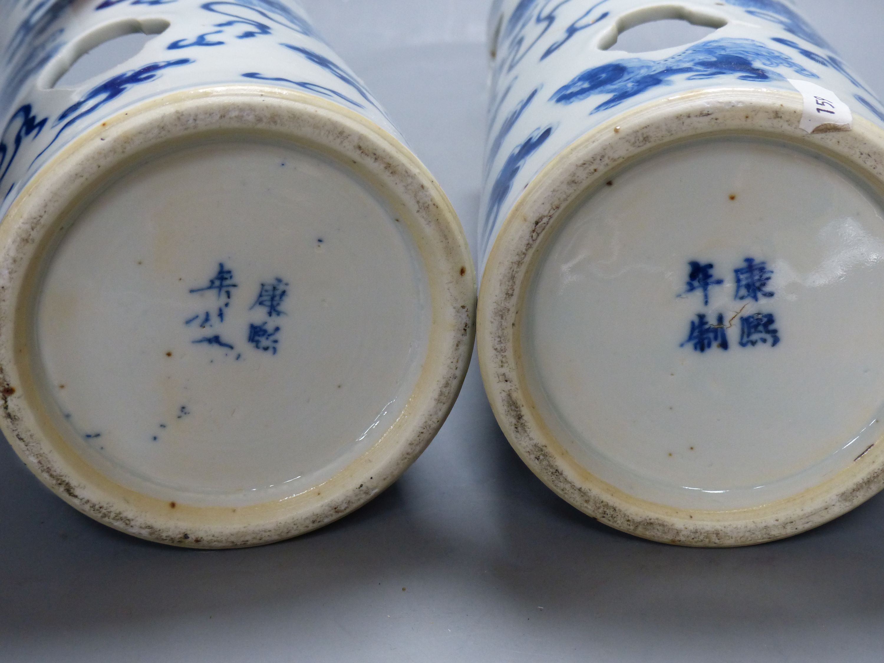 A pair of early 20th century Chinese blue and white hat stands, Kangxi marks, 29cm high